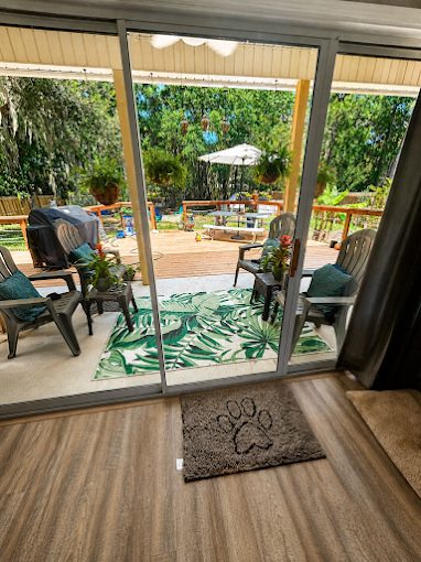 Sliding door open to a backyard deck
