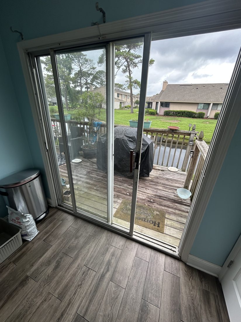 Sliding glass door repaired and operating smoothly onto a deck