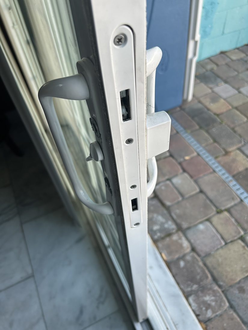 Close-up of sliding door handle and lock hardware